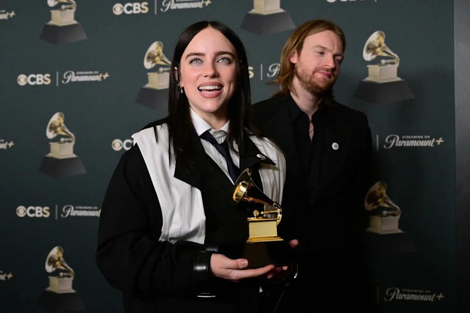 Billie Eilish and her brother Finneas O’Connell pose with the award for Song of the Year for “Wildflower” AFP via Getty Images