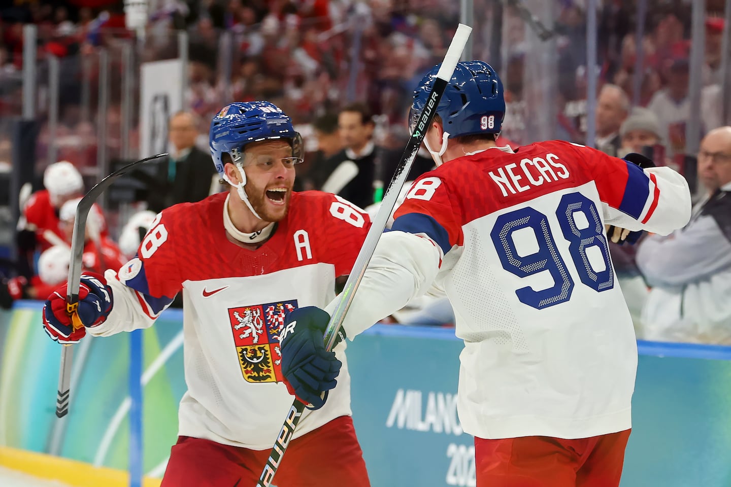 Bruins star David Pastrnak (left), celebrating a goal by teammate Martin Necas, powers Czechia into the knockout stages, where they will face off vs. Denmark.