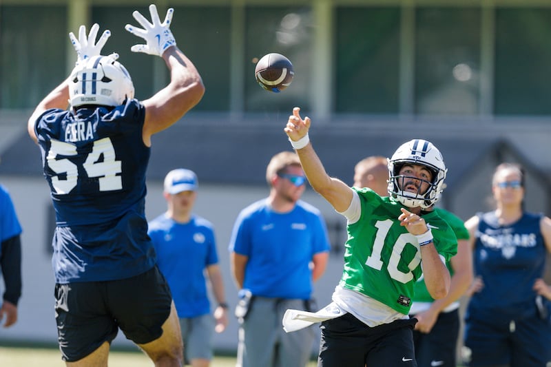 BYU quarterback Treyson Bourguet launches a pass Thursday afternoon during Day 2 of the Cougars' fall camp in Provo.
