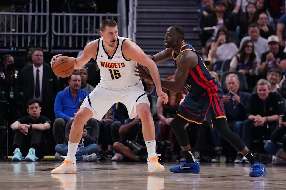 Apr 4, 2025; San Francisco, California, USA; Denver Nuggets center Nikola Jokic (15) is guarded by Golden State Warriors forward Draymond Green (23) in the third period at Chase Center. Mandatory Credit: David Gonzales-Imagn Images