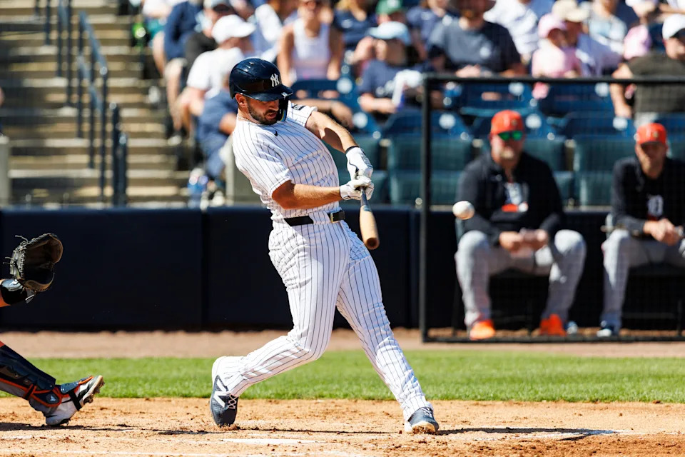 Feb 21, 2026; Tampa, Florida, USA; New York Yankees infielder Paul DeJong (18) hits a single against the Detroit Tigers in the during the third inning in a Spring Training game at George M. Steinbrenner Field. Mandatory Credit: Morgan Tencza-Imagn Images