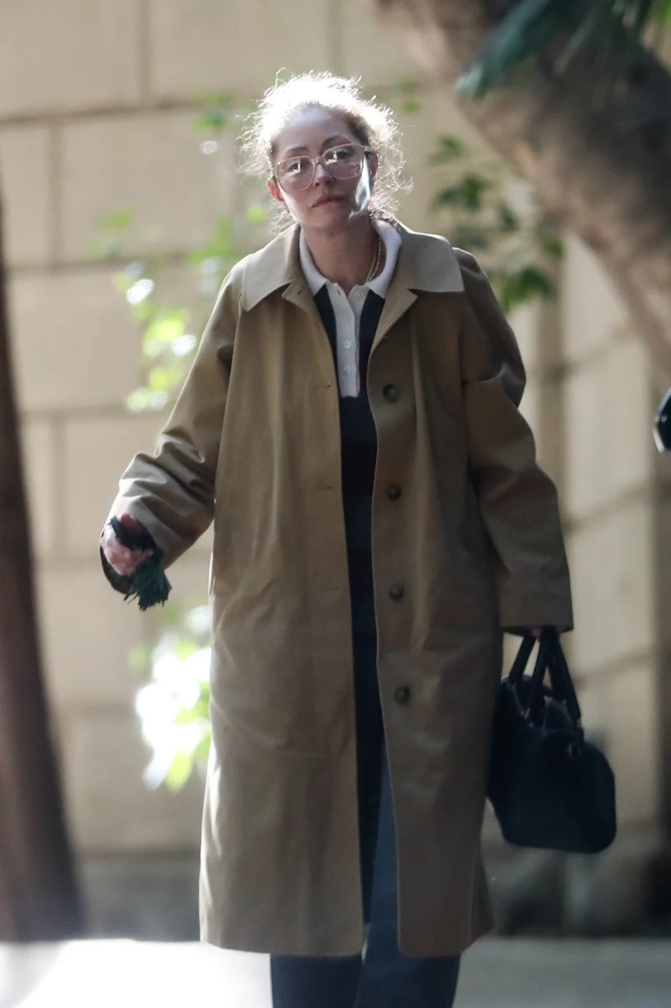 The actress wore a beige trench coat while leaving the home Dane was staying in prior to his death. BACKGRID