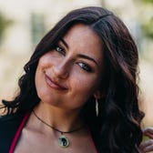 Tess is smiling at the camera.