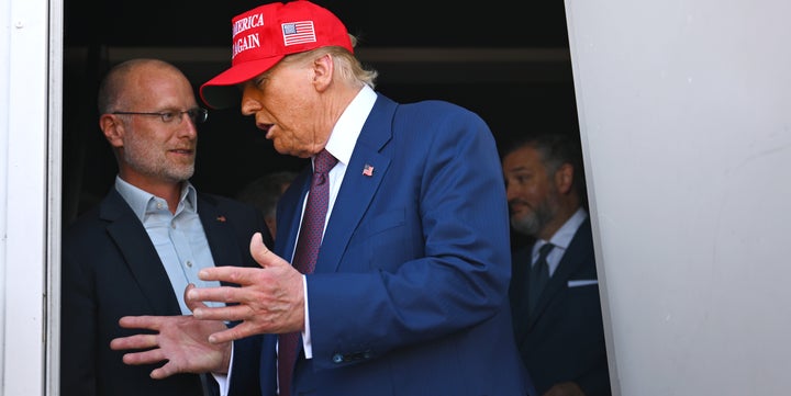 Donald Trump speaks to Brendan Carr on November 19, 2024. (Photo by Brandon Bell/Getty Images)