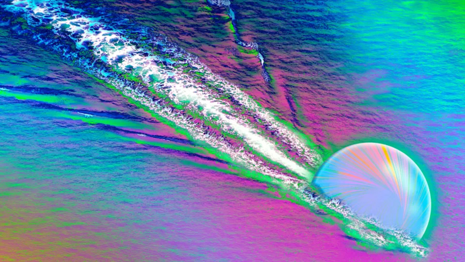  An illustration shows a quark racing through thye primordial soup or quark-gluon plasma that filled the early universe, creating a wave. 