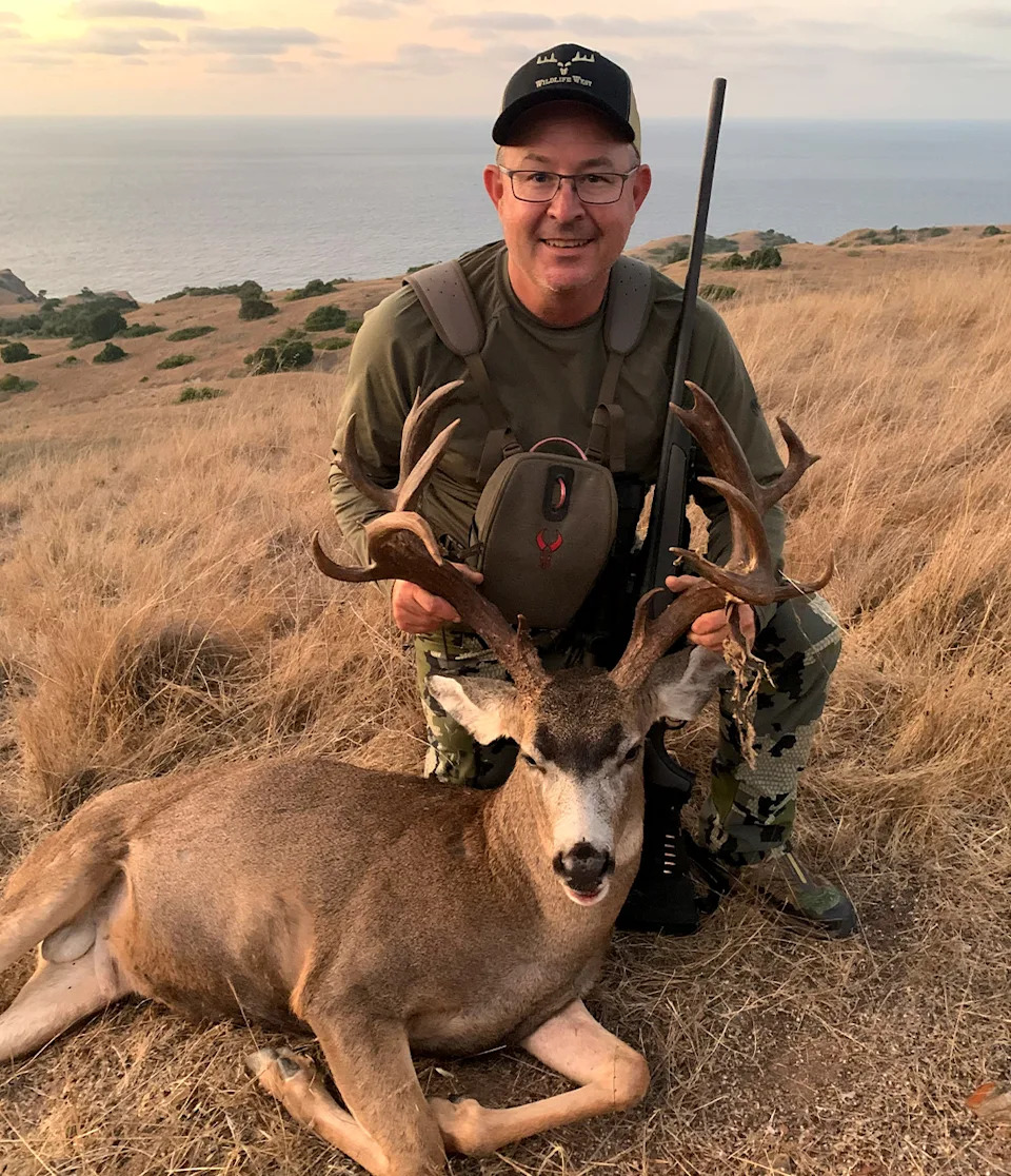 A hunter with a buck tagged on Catalina Island.