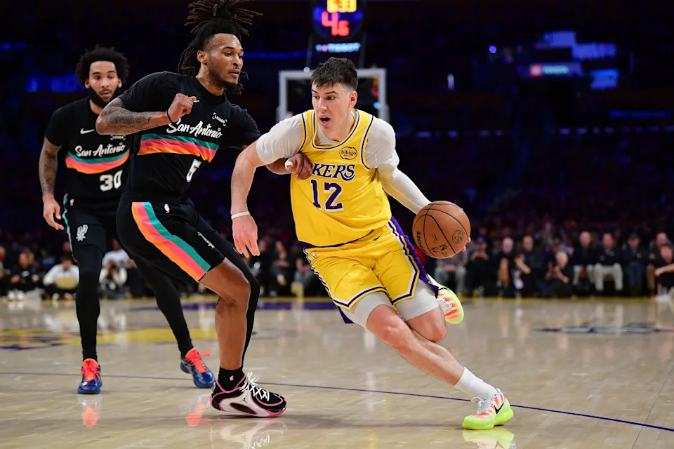 Feb 10, 2026; Los Angeles, California, USA; Los Angeles Lakers forward Jake LaRavia (12) moves to the basket against San Antonio Spurs guard Stephon Castle (5) during the first half at Crypto.com Arena. Mandatory Credit: Gary A. Vasquez-Imagn Images