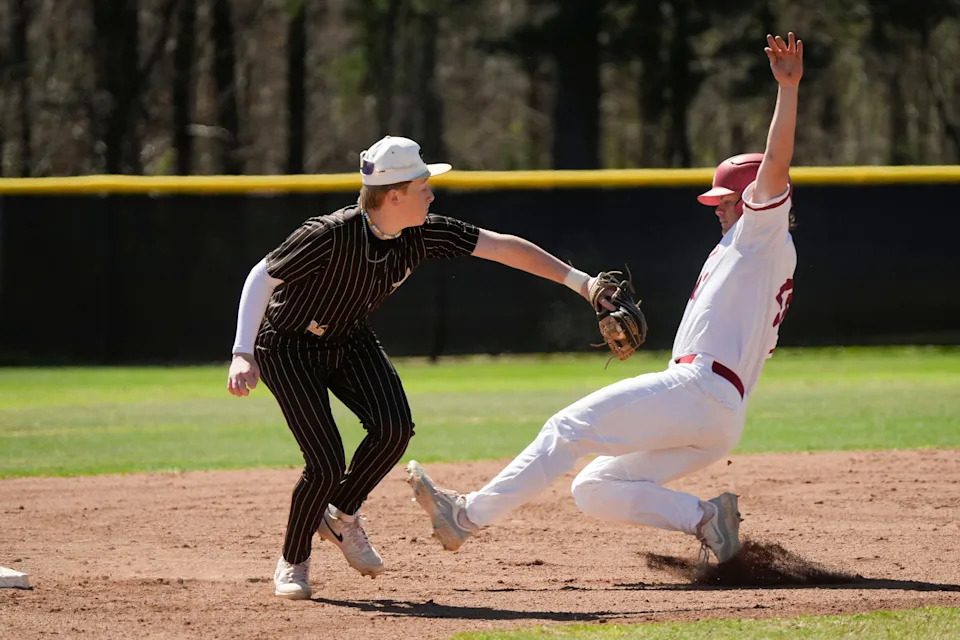 Mar 17, 2025; Tuscaloosa AL, USA; Hale County shortstop Kolt Young takes a throw wide of second base as Brookwood runner Judson Bryant steals second. Brookwood defeated Hale County 6-1 Monday in Brookwood.