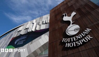 A Tottenham Hotspur logo on a wall outside Tottenham Hotspur Stadium