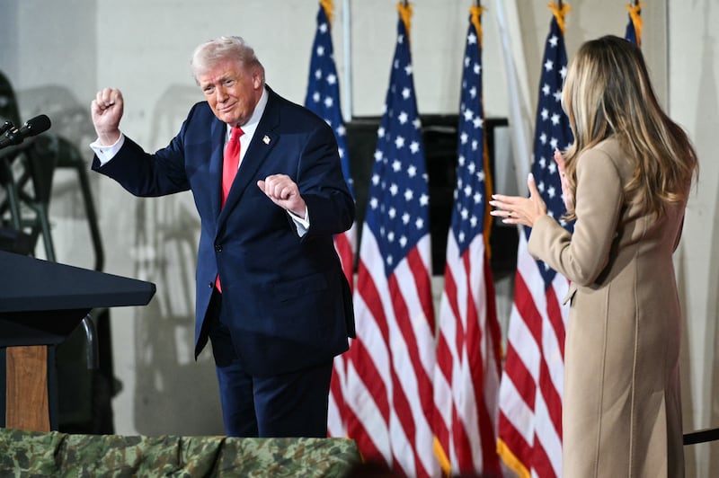 Donald Trump dances on stage next to Melania