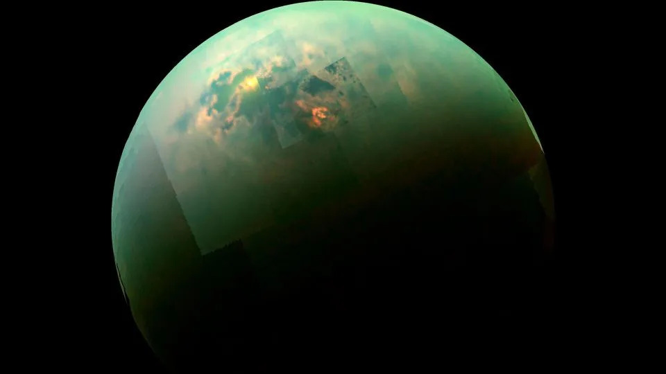 A view of Titan from Cassini, with the sun illuminating the moon's north polar seas. - NASA/JPL-Caltech/University of Arizona/University of Idaho
