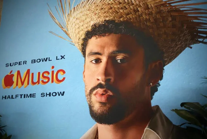 A person wearing a straw hat is featured in a promotional image for the Super Bowl LX Apple Music Halftime Show