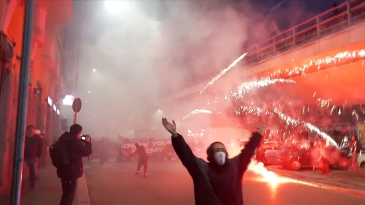 <p>Protesters setting off fireworks and flares in Milan on Saturday </p>