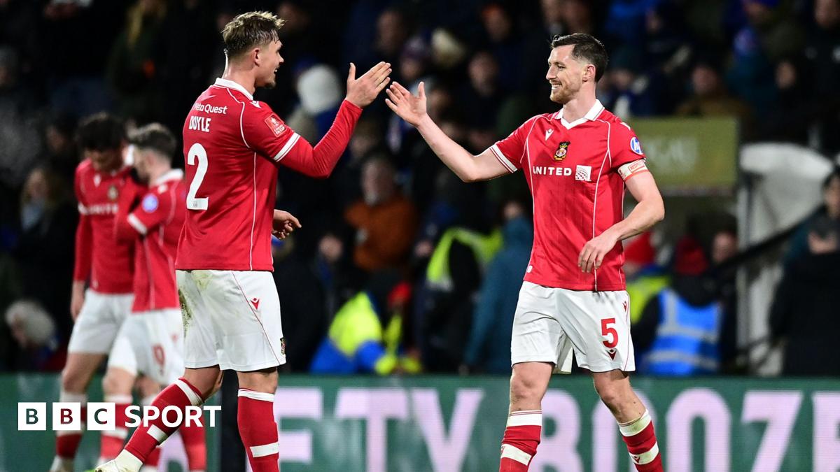 Wrexham's Dominic Hyam celebrates with team-mate Callum Doyle at the final whistle during the Emirates FA Cup Fourth Round match between Wrexham and Ipswich Town