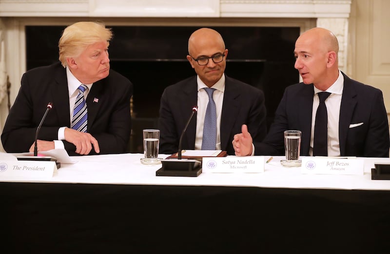 Donald Trump, Microsoft CEO Stya Nadella and Amazon CEO Jeff Bezos attend a meeting of the American Technology Council in the State Dining Room of the White House June 19, 2017 in Washington, DC.