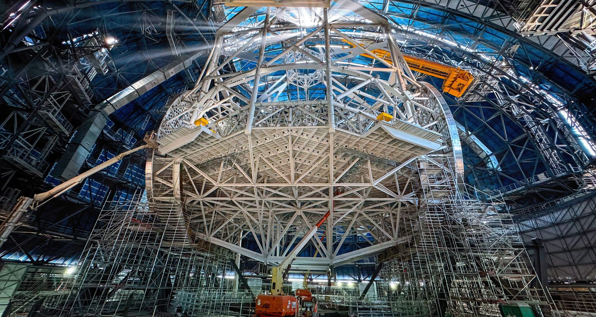 An image of a construction site with a large circular scaffolding in the middle of the scene.