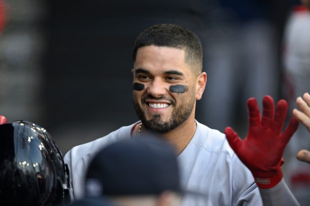 Boston Red Sox's Carlos Narvaez celebrates with teammates in the dugout after scoring on a Ceddanne Rafaela triple during the fifth inning of a baseball game against the Chicago White Sox, Saturday, April 12, 2025, in Chicago. (AP Photo/Paul Beaty)
