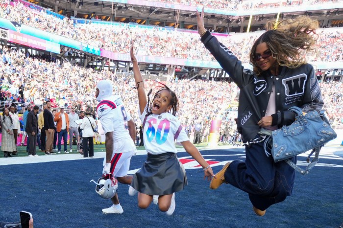 Blue Ivy Carter and Rumi Carter do a pregame jump in the end zone.