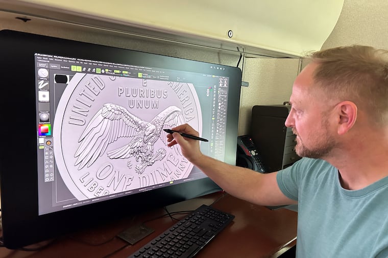 Medallic artist Eric David Custer at his workstation, showing his design for the tails side of the semiquincentennial dime on a computer screen.