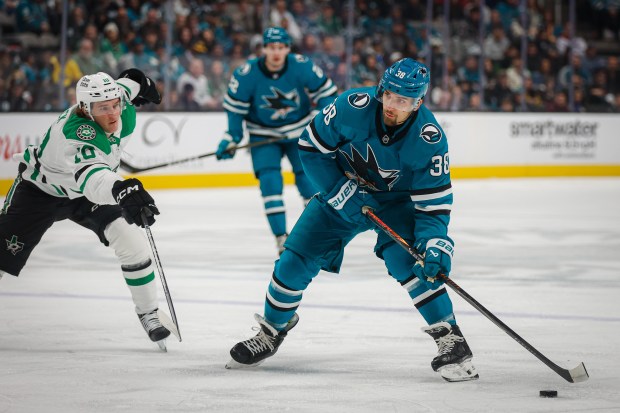 San Jose Sharks' Mario Ferraro (38) skates with the puck against Dallas Stars' Oskar Back (10) during the first period at SAP Center in San Jose, Calif., on Saturday, Jan. 10, 2026. (Shae Hammond/Bay Area News Group)