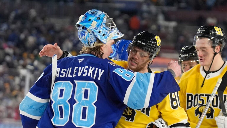 Tampa Bay Lightning goaltender Andrei Vasilevskiy (88) hugs Boston Bruins right wing David Pastrnak after the Lightning defeated the Bruins during a shootout in a Stadium Series NHL hockey game Sunday, Feb. 1, 2026, in Tampa, Fla.
