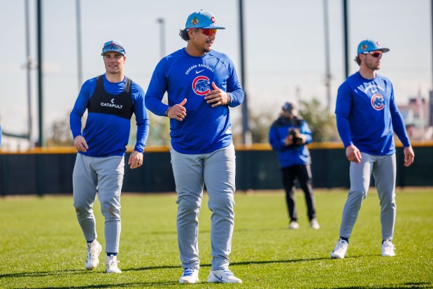 Matt Shaw, from left, Miguel Amaya and Nico Hoerner warm up during Cubs spring training at Sloan Park on Feb. 19, 2026 in Mesa, Ariz. (Armando L. Sanchez/Chicago Tribune)