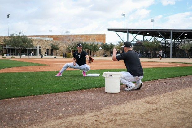 White Sox shortstop Colson Montgomery, left, works with third-base coach Justin Jirschele during spring training at Camelback Ranch on Feb. 18, 2026, in Glendale, Ariz. (Eileen T. Meslar/Chicago Tribune)