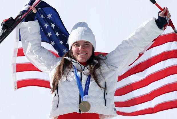 Gold medalist Breezy Johnson poses for a photo during the medal ceremony for the women's downhill on Feb. 8, 2026, at Tofane Alpine Skiing Centre. (Ezra Shaw/Getty Images)