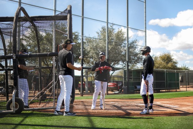 Chicago White Sox left fielder Austin Hays, right, speaks to left fielder Andrew Benintendi, center, while taking batting practice during spring training at Camelback Ranch in Glendale, Ariz., on Tuesday, Feb. 17, 2026. (Eileen T. Meslar/Chicago Tribune)