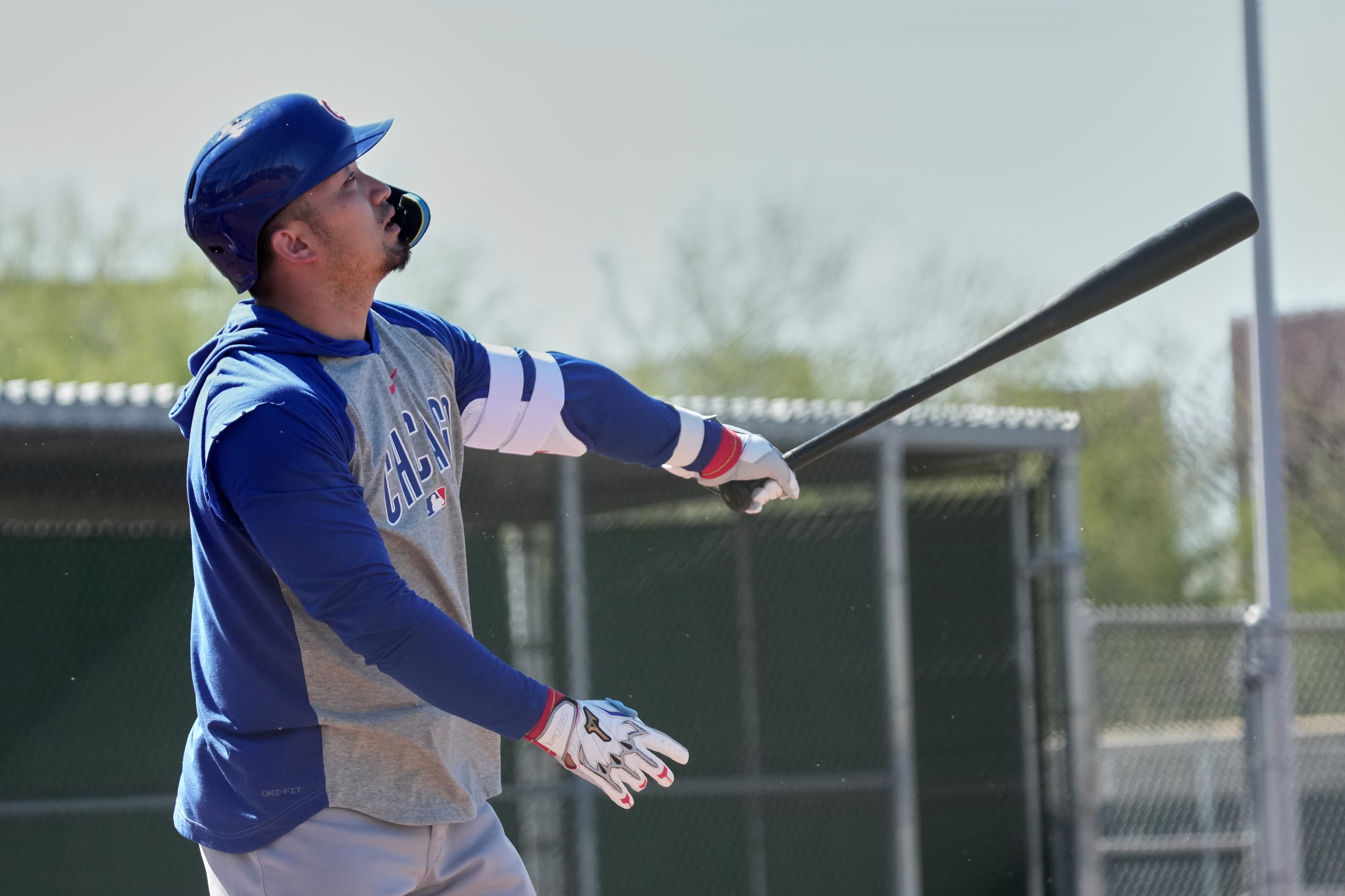 Cubs right fielder Seiya Suzuki hits during a spring training...