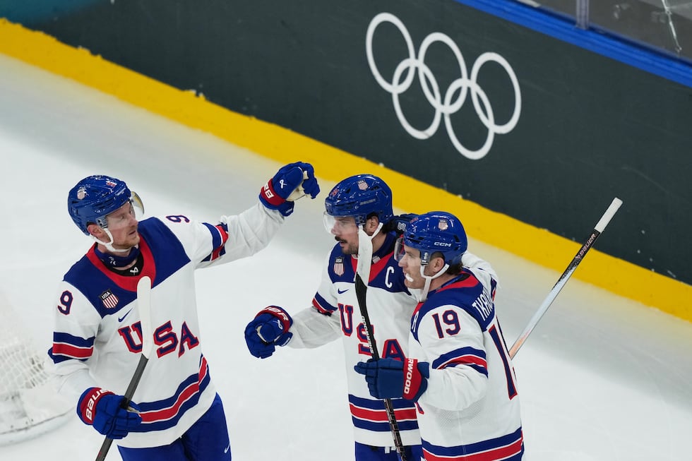 United States' Auston Matthews, center, celebrates with teammates after scoring his sides...