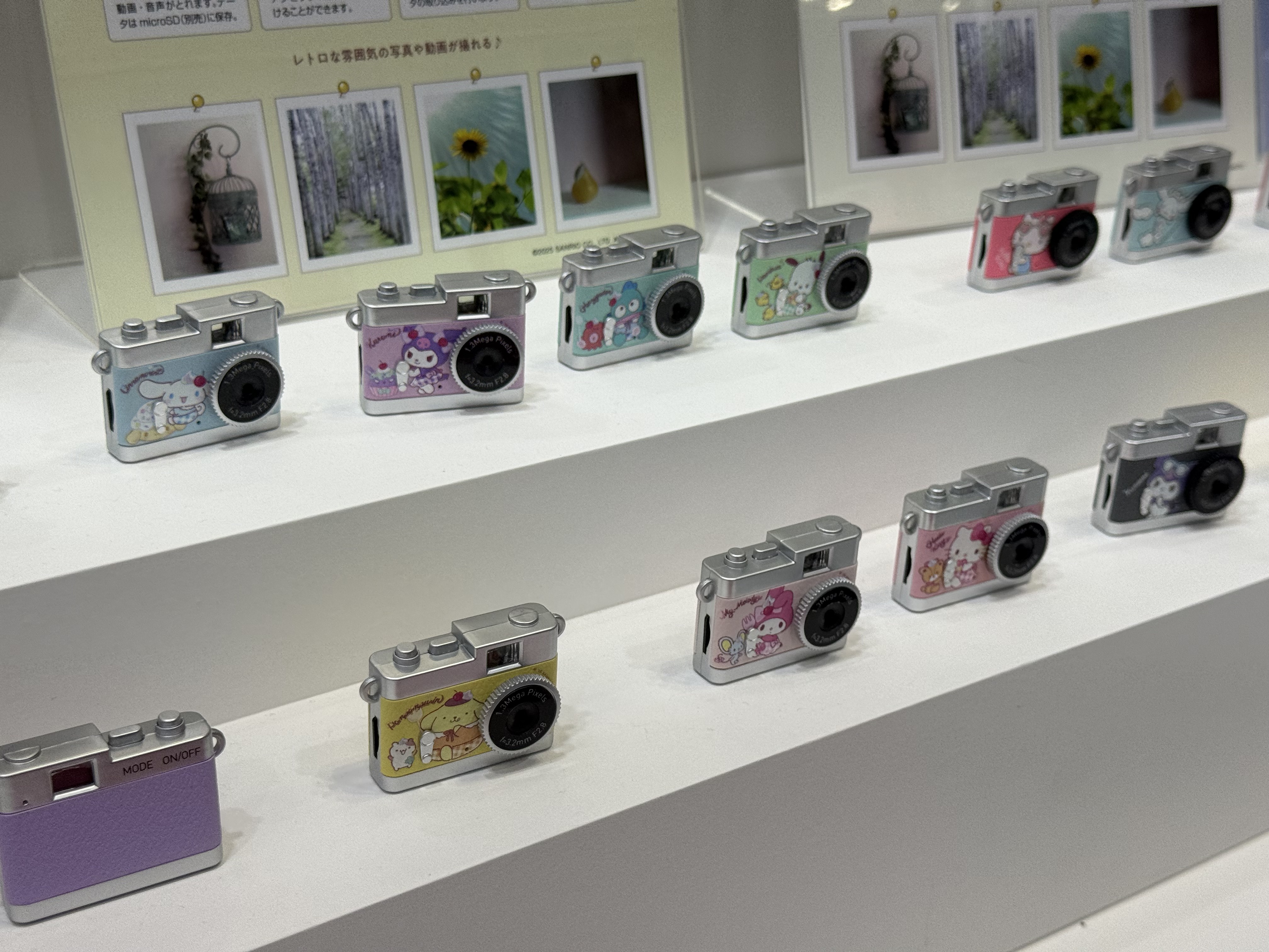 An array of colorful digital point and shoot cameras on display at the CP+ 2026 show