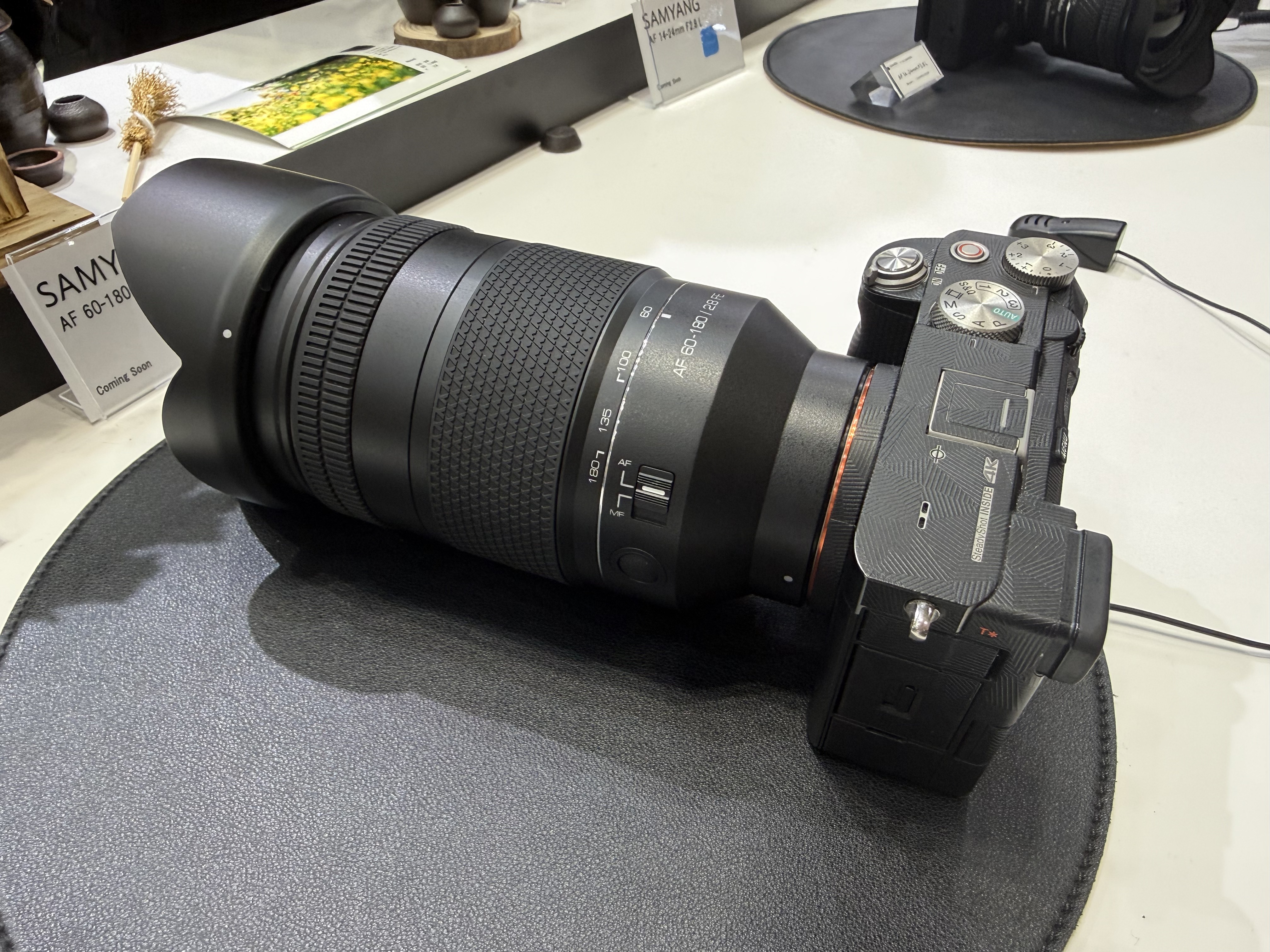 A Samyang lens on display at the CP+ show, attached to a Sony camera