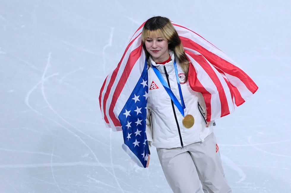 Alysa Liu of the United States celebrate with the crowd after Team USA wins gold in the figure...