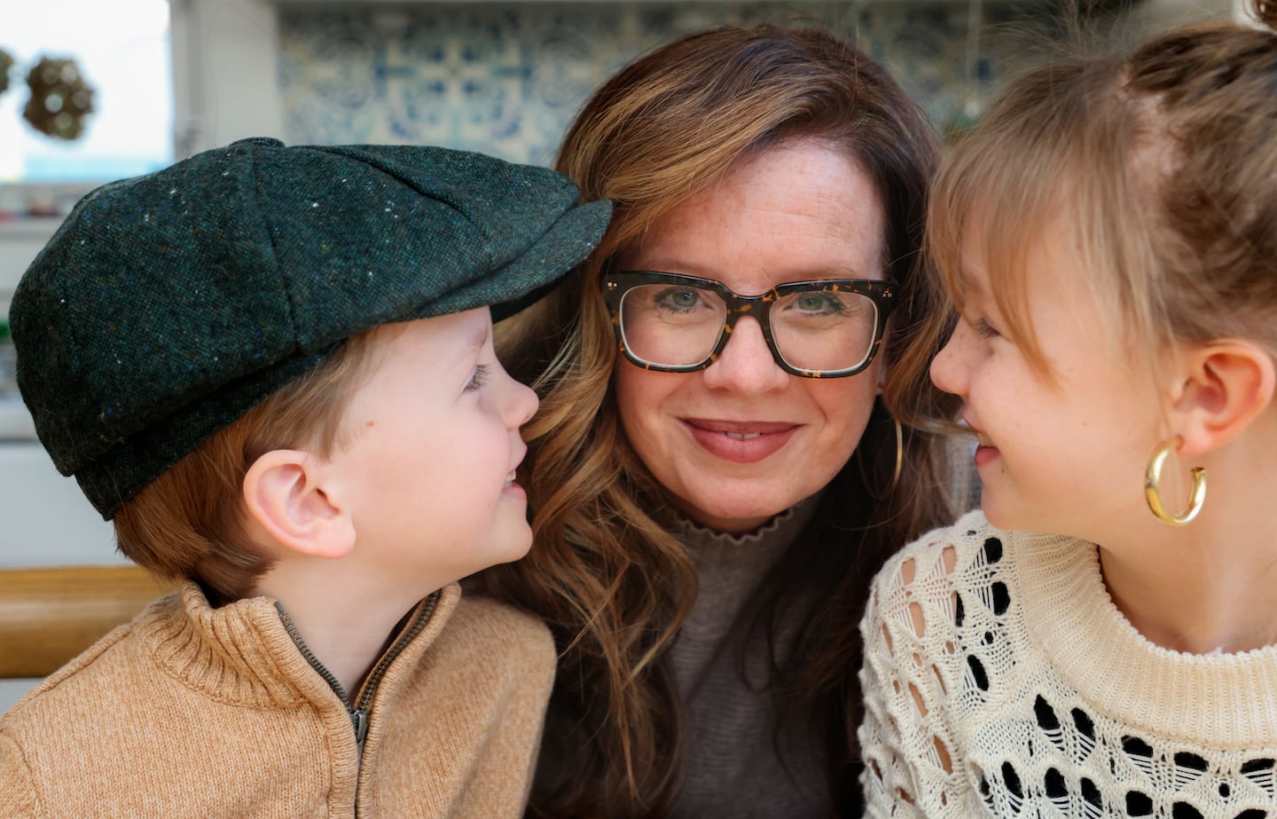 Katherine Loftus with her kids, Joseph, 6 and Gracie, 9 in their living room on January 12. Loftus grew up in South Boston with a strong Boston accent, but her two children don't and ofter tease her.