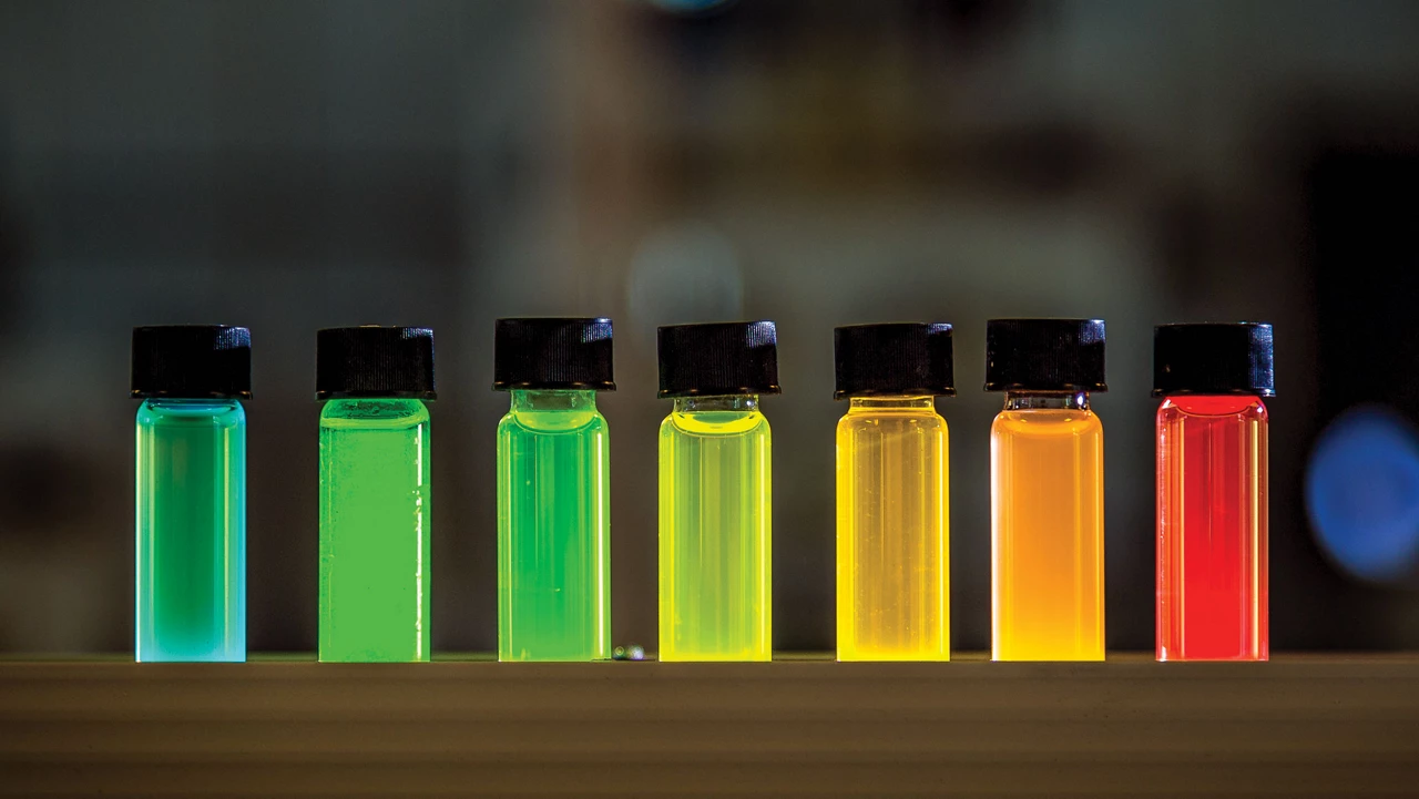 7 small vials filled with brightly colored liquids