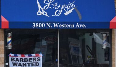 Hiring sign is displayed at a barbershop in Chicago, Thursday, Feb. 5, 2026. (AP Photo/Nam Y. Huh)