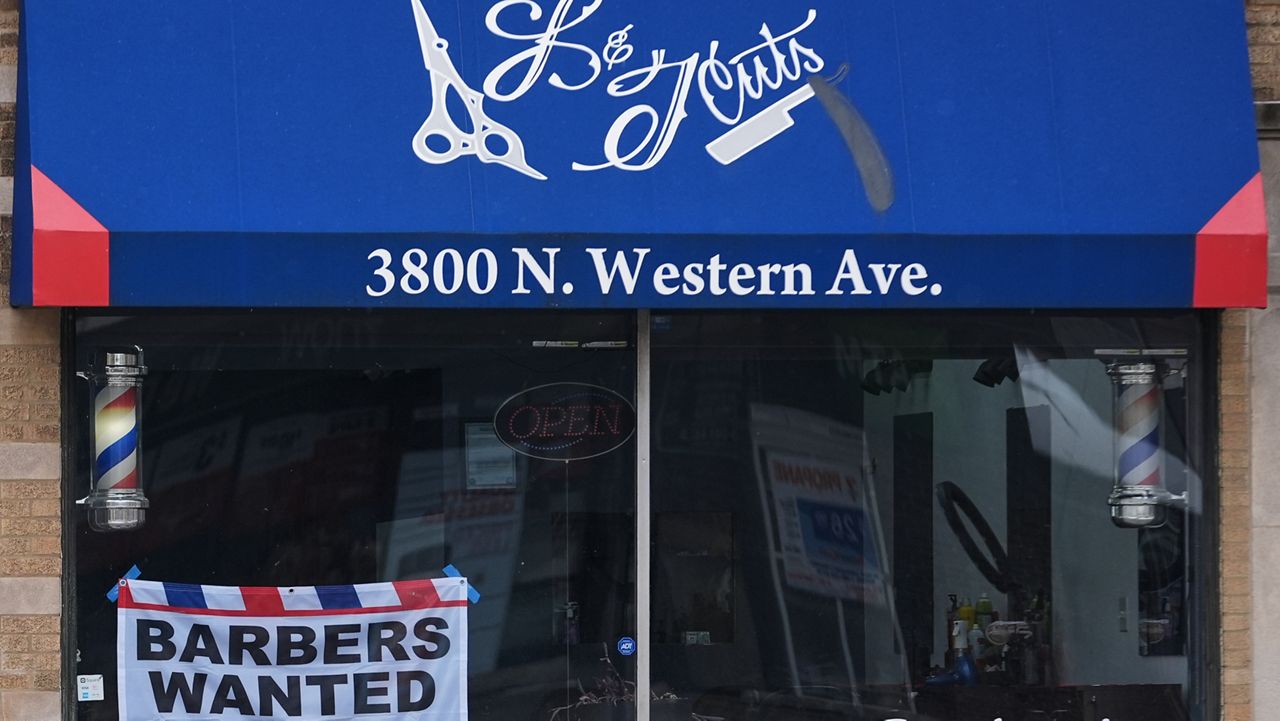 Hiring sign is displayed at a barbershop in Chicago, Thursday, Feb. 5, 2026. (AP Photo/Nam Y. Huh)