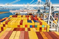 FILE - Cargo containers line a ship at the Port of Oakland on Wednesday, Aug. 6, 2025, in...