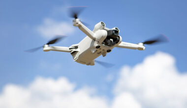 DJI's Mini 3 Pro drone flying in the sky.