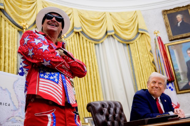 President Donald Trump, accompanied by entertainer Kid Rock, takes a question from a reporter during an executive order signing event in the Oval Office of the White House on March 31, 2025 in Washington, DC. (Photo by Andrew Harnik/Getty Images)