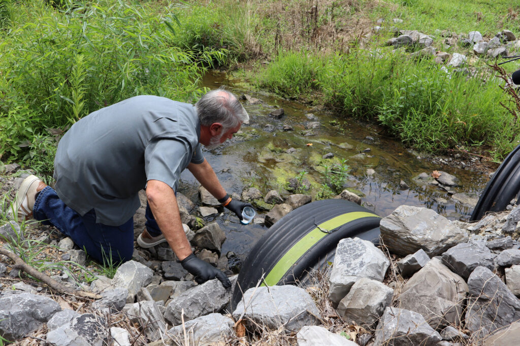 Water quality expert Bob Bowcock tests a creek for cancer-causing PFAS “forever chemicals” at a property in Dalton, Ga., on June 12, 2025. Credit: Issam Ahmed/AFP via Getty Images