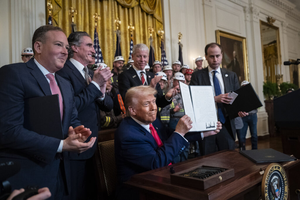 The photo in the White House shows other administration officials and coal miners.