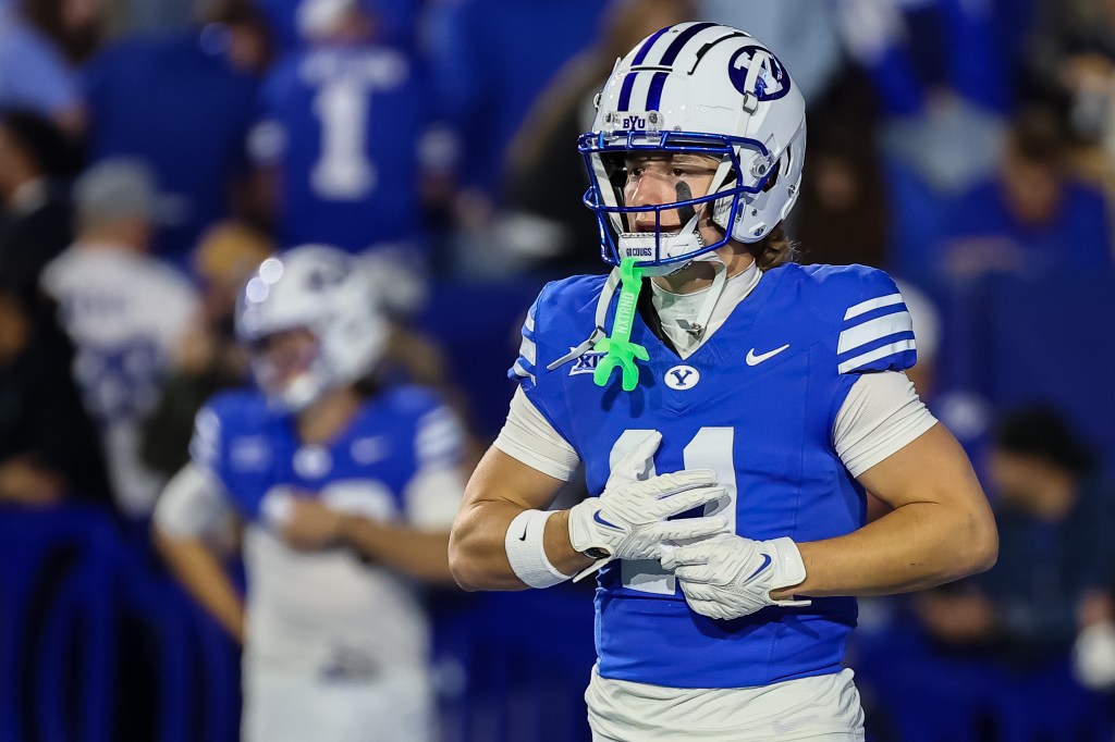 A BYU football player in a blue jersey and white helmet with a "Y" logo.