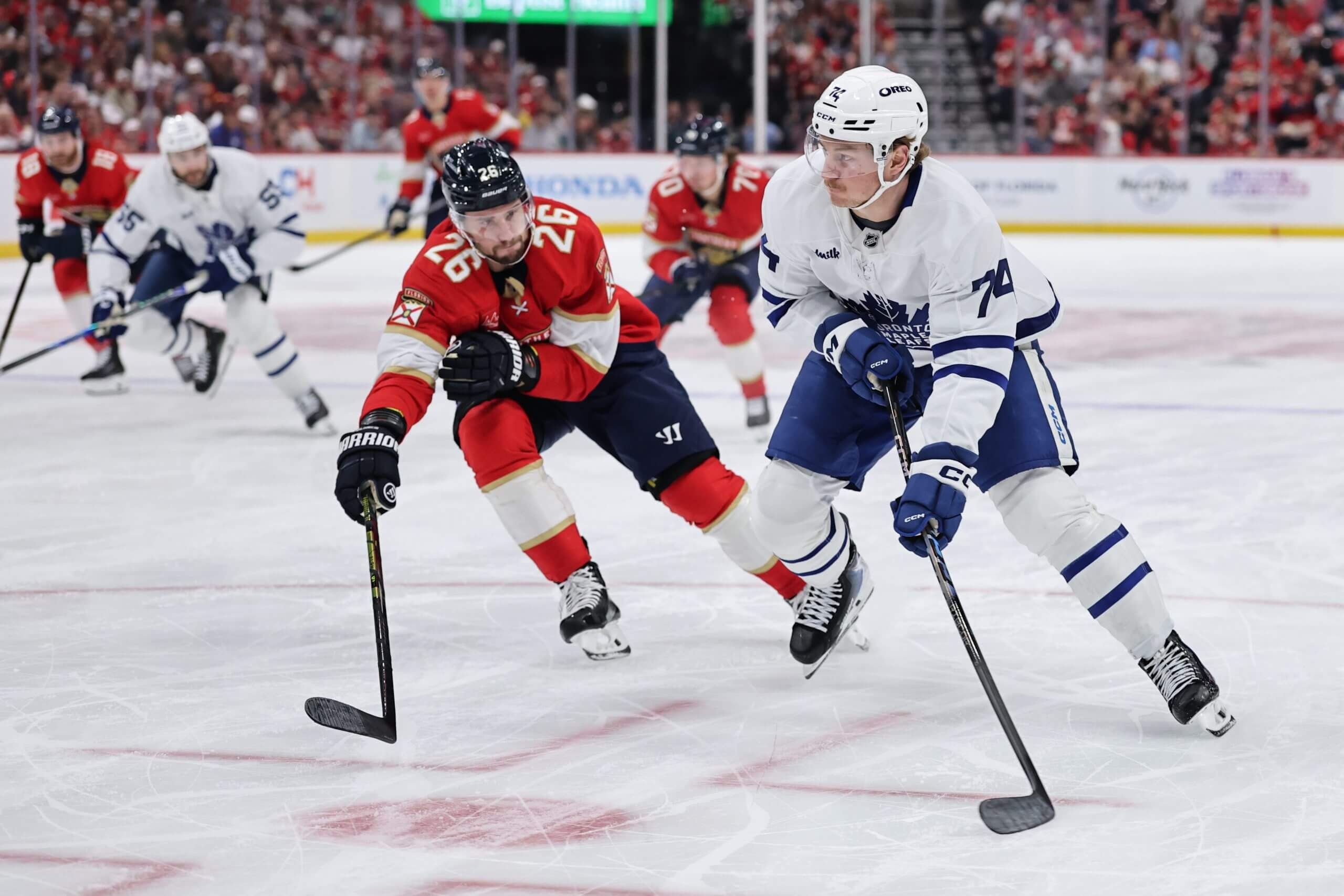 Bobby McMann looks for a pass with a Florida Panthers player defending.
