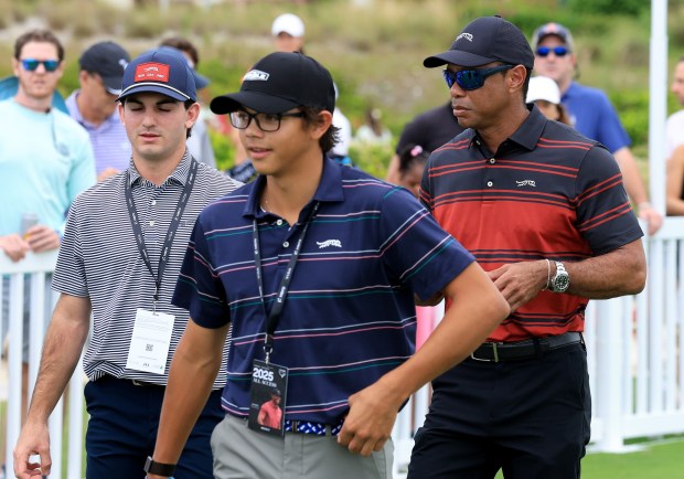 Tiger Woods of the United States leaves the driving after watching the players warm up with his son Charlie Woods (L) during the final round of the Hero World Challenge 2025 at Albany Golf Course on Dec. 7, 2025 in Nassau, Bahamas. (Photo by David Cannon/Getty Images)