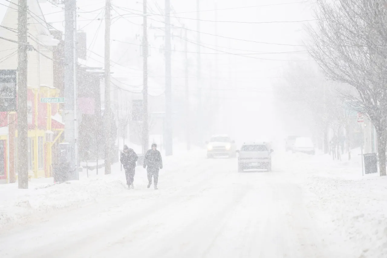 People walk the streets in near whiteout conditions on January 25, 2026 in Louisville, Kentucky. (Photo by Jon Cherry/Getty Images)