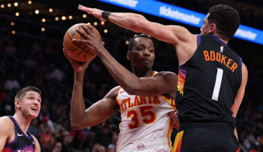 ATLANTA, GEORGIA - JANUARY 23: Christian Koloko #35 of the Atlanta Hawks drives against Devin Booke...