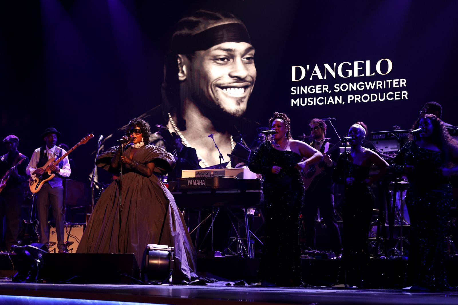 Image may contain D'Angelo Hella Joof Anita Baker Adult Person Wedding Concert Crowd Performer and Solo Performance