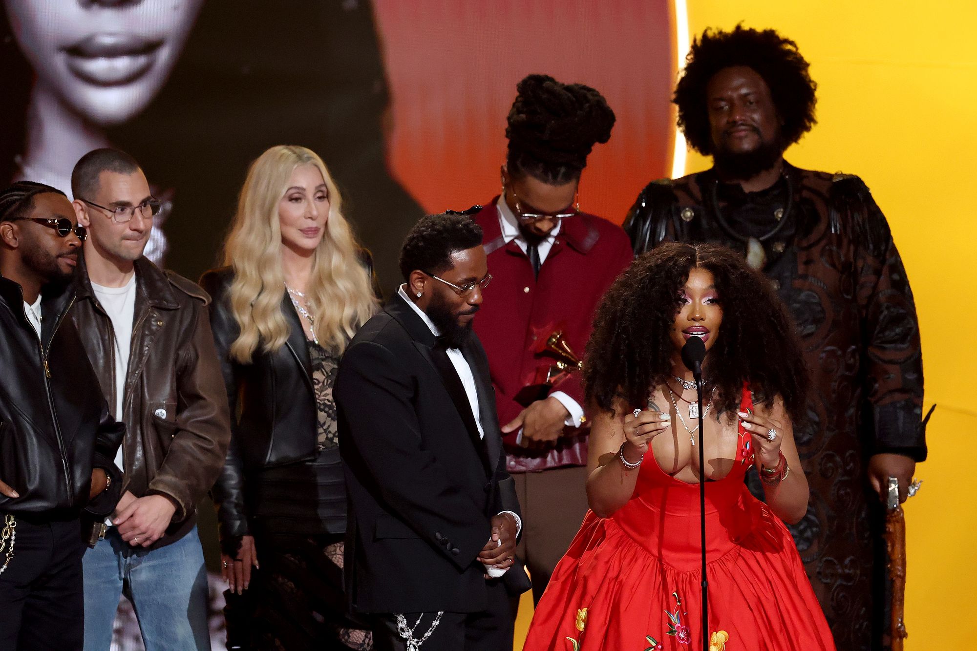 SZA urges fans not to give in to despair as she and Kendrick Lamar accept the Grammy for Record of the Year for ‘Luther’